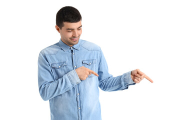 Young man pointing at something on white background