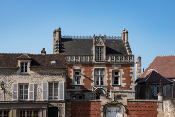 Façade of an old red brick house with beautiful sculptures