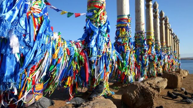 Baikal Lake. Olkhon island. Video of sacred place on Cape Burkhan with 13 serge pillars. Buryat colorful scarves or khodaks are tied to them, asking the spirits for help and health