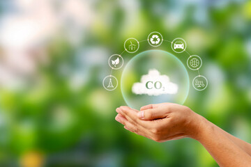 CO2 symbol on cloud in human hand. Concepts about the issue of carbon dioxide emissions and their...