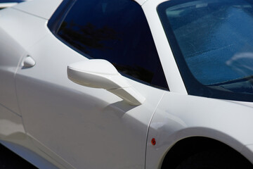Close up of a white sport car parked in the marina.
