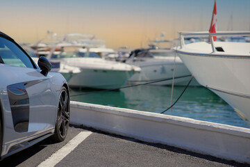 Luxury sports car on the background of yachts.