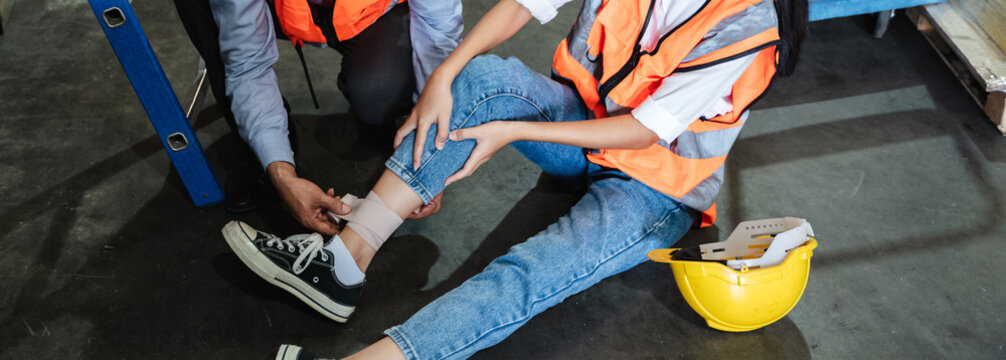 A female warehouse worker has an accident from falling from a height while working in a factory.