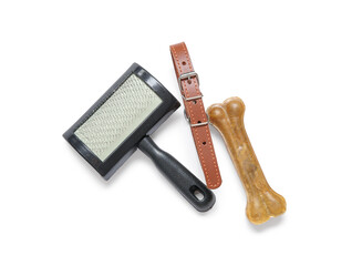 Pet collar, grooming brush and chew bone on white background