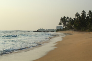 Beach with golden sand and blue ocean water on most popular Unawatuna