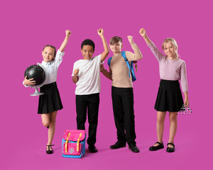 Little classmates in stylish uniform with globe, molecular model and backpacks on purple background