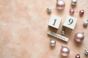Calendar with date 19 DECEMBER and Christmas decor on beige grunge background