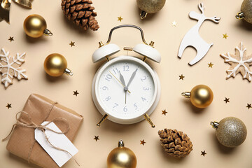 Composition with alarm clock, gift box and beautiful Christmas decorations on color background