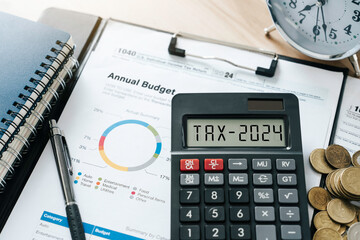 Word Tax 2024 on the calculator and with coins and form for planning annual budget and business tax concept. Tax deduction planning.Financial research, government taxes, and calculation of tax return - obrazy, fototapety, plakaty