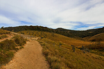 Hiking Trail, grassy plains and hills, in Horton Plains National Park, Sri Lanka