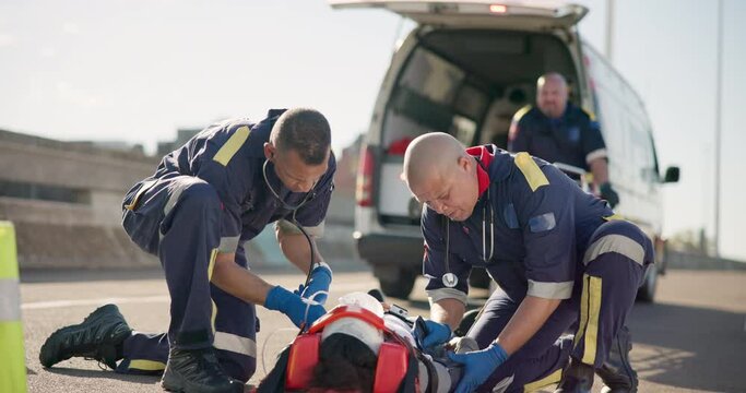 Paramedic team, patient and stretcher on road, emergency or safety with medical attention. EMS first responder, healthcare services and accident on street for care, support and transport in ambulance
