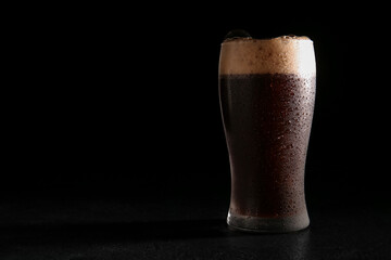 Glass of dark beer on black background - obrazy, fototapety, plakaty