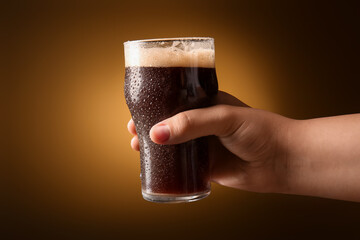 Woman holding glass of dark beer on yellow background - obrazy, fototapety, plakaty