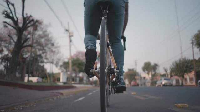 A man enjoys a bike ride on a dedicated cycle path, promoting healthy living and eco-friendly transportation in an urban setting.