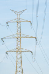 high voltage pylon against the blue sky, electricity supplier