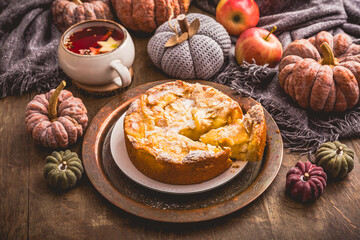 Apple pie with almonds and cup of herbal fruit tea for Thanksgiving