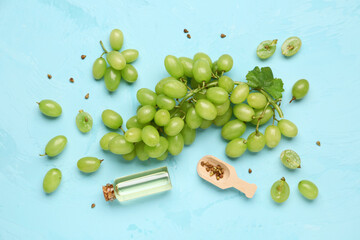 Composition with fresh white grapes and essential oil on color background