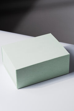 Square gift box, luxury shopping, mock up. White and gray background. Studio shot