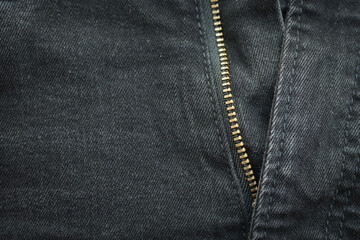 black denim clothing texture background, front of pants fashion with zip