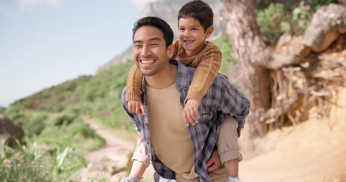 Piggyback, kid or father hiking in nature with smile or fitness for adventure, trekking or freedom. Boy child, mountain or dad walking outdoor for wellness, travel or exercise on holiday vacation