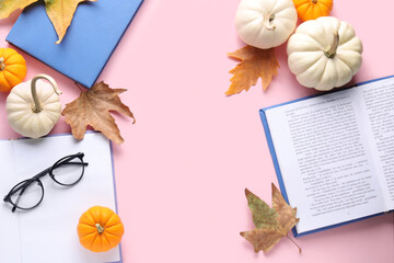 Composition with books, eyeglasses and autumn decor on pink background