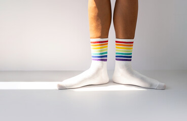 Human legs wearing rainbow socks as LGBT flag.