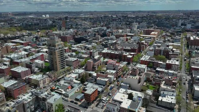 Aerial flyover Brooklyn District with housing area and avenues during sunny days in New York City