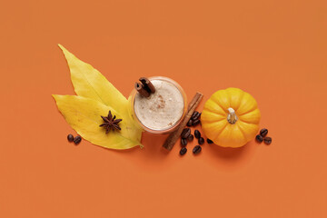 Composition with cup of aromatic coffee, pumpkin and autumn leaves on color background
