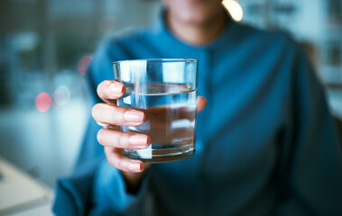 Water, glass and hand closeup in office, woman and giving for hydration, wellness or choice at...