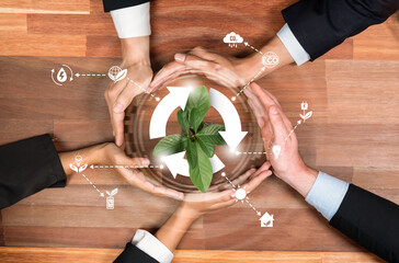Business partnership holding plant together with recycle icon symbolize ESG sustainable environment...
