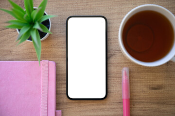 phone with isolated screen wooden table pink notepad in cafe