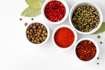 Various spices in a bowls on white background