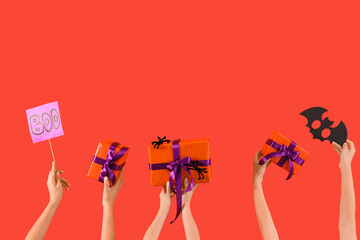 Women with Halloween gifts and decor on red background