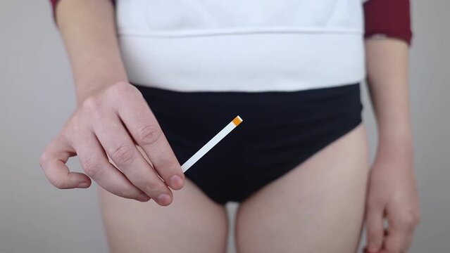 Bacterial Vaginosis. Vaginal pH. Girl shows sticks for measuring acid-base balance of genital organs. Self-diagnosis. Normal acidity level shown in colors and must be compared with the standard