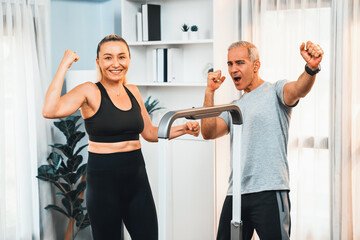 Fototapeta na wymiar Athletic and sporty senior couple portrait in sportswear with successful or celebrating after overcome struggle posture as home exercise concept with healthy fit body lifestyle after retirement. Clout