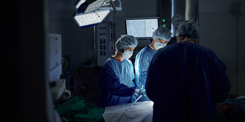 Surgery, dark room and doctors with healthcare, teamwork and support with wellness, safety and...