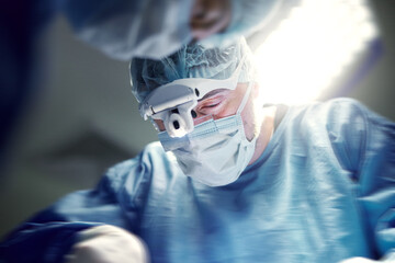 Headlight, healthcare and doctors in a hospital for surgery together, working in theater to save a...