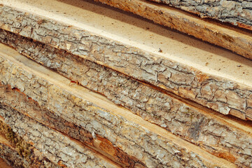 Background from large stacked wooden boards close up