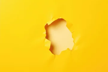 Fotobehang paper hole with torn sides on yellow background © Anatolii