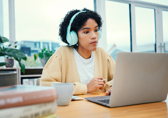 Serious, headphones and business woman on laptop working in creative startup office. Radio music,...