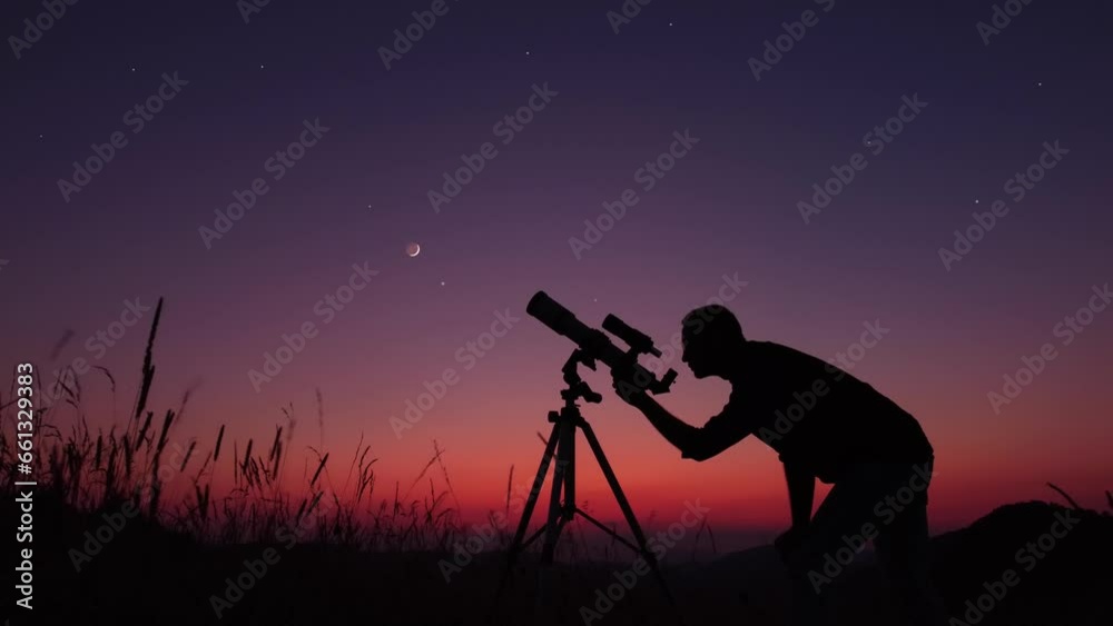 Canvas Prints astronomer looking at the stars, planets, moon and celestial objects with a telescope.