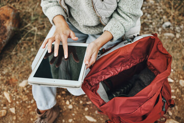 Hands, hiking and a person with a tablet in nature for gps location, search or online for travel....