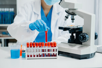 Modern medical research laboratory. female scientist working with micro pipettes analyzing biochemical samples, advanced science chemical laboratory