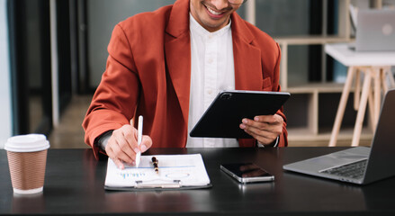 Businessman using on smartphone and tablet and laptop at moderm office as concept