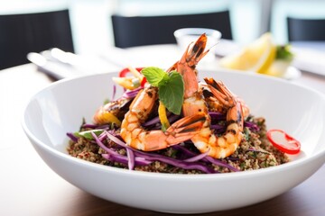 quinoa salad with grilled prawns served in a white dish