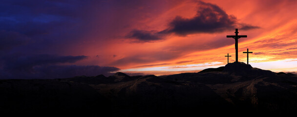Golgotha hill landscape with dramatic and majestic red sky and clouds, cross silhouette symbolizing Jesus Christ's passion and death during Passion Week and Easter background

