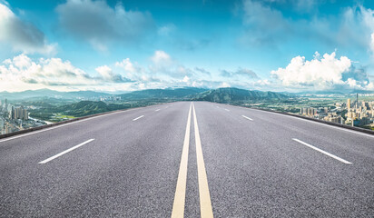 Clean asphalt road with mountains and skyline background in Shenzhen - obrazy, fototapety, plakaty