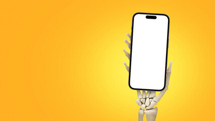 Skeleton hand holding smartphone on orange background, Halloween concept. Advertising and...