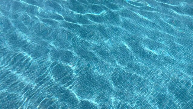 texture of blue water ripples in the swimming pool