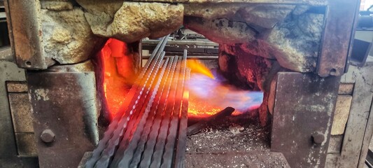 Rebar in a burning furnace in wrought iron production.